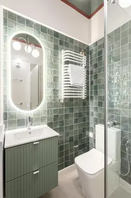 a bathroom with a sink and a toilet and a mirror at Katie's Apartment in Kraków