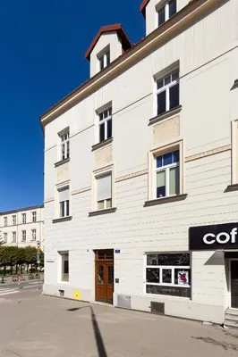 a white building with aoc sign on the side of it at Katie's Apartment in Kraków