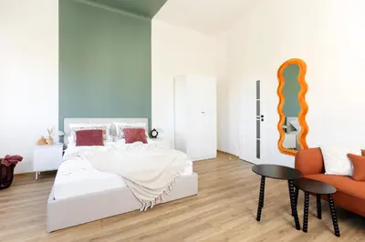 a bedroom with a bed and a table and a chair at Katie's Apartment in Kraków