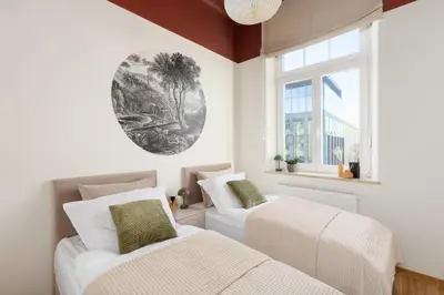 a bedroom with two beds and a window at Katie's Apartment in Kraków