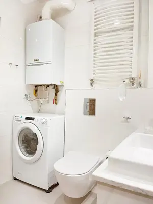 a white bathroom with a washing machine and a toilet at Secret Garden Kraków - Wonderful City Centre Apartment - Ground Floor - Quiet Location in Kraków
