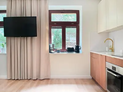 a kitchen with a sink and a window at Secret Garden Kraków - Wonderful City Centre Apartment - Ground Floor - Quiet Location in Kraków