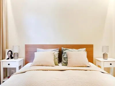 a bedroom with a large bed with two night stands at Secret Garden Kraków - Wonderful City Centre Apartment - Ground Floor - Quiet Location in Kraków