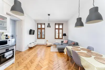 a living room with a table and a couch at Dietla Avenue Charm Apartment by BookingHost in Kraków