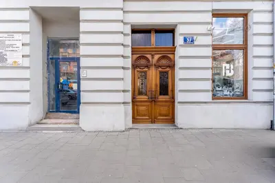 a building with a wooden door on a street at Dietla Avenue Charm Apartment by BookingHost in Kraków