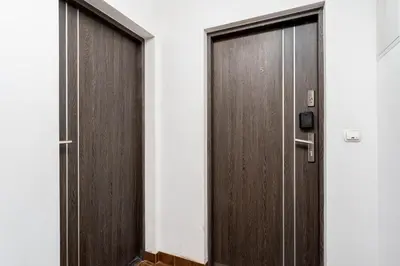 a pair of wooden doors in a building at Dietla Avenue Charm Apartment by BookingHost in Kraków