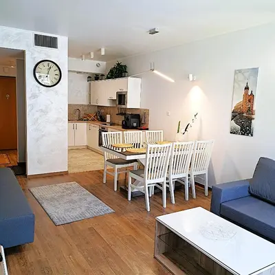 a living room with a blue couch and a table at Luxury Modern Apartment in Kraków