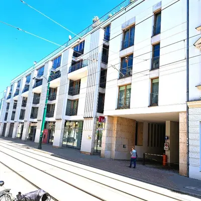 a person standing in front of a building at Luxury Modern Apartment in Kraków