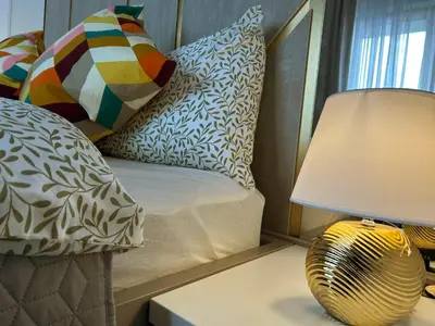 a bedroom with a couch and a lamp and pillows at HolidayHome Kraków Center in Kraków