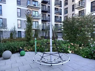 a metal structure with a pole in front of a building at HolidayHome Kraków Center in Kraków