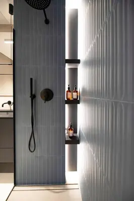 a shower in a bathroom with a wall with shelves at Luxury penthouse with large terrace in Kraków