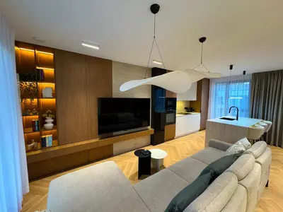 a living room with a couch and a television at Luxury penthouse with large terrace in Kraków