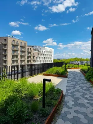 a walkway in front of a building with a fence at Luxury penthouse with large terrace in Kraków