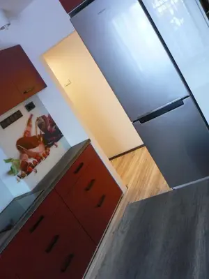 a kitchen with red cabinets and a counter top at Apartment Poland in Sułkowice