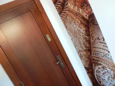 a door in a room with a surfboard next to it at Apartment Poland in Sułkowice