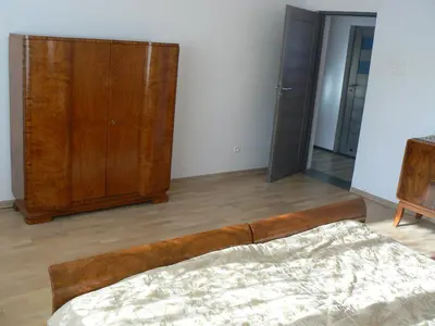 an unmade bed with pillows and a blanket at Apartment Poland in Sułkowice