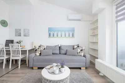 a living room with a couch and a table at Modern Apartment with Air Conditioning and Parking in Cracow by Noclegi Renters in Kraków