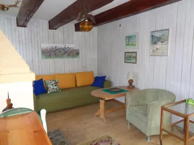 a living room with a couch and a table at Uroczy Domek Z Ogrodem I Tarasem in Myślenice