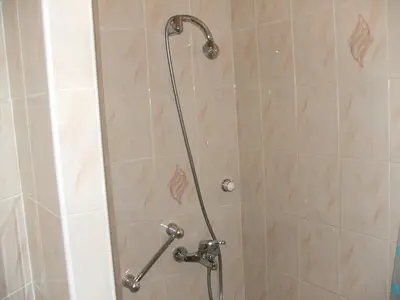 a shower with a shower head in a bathroom at Uroczy Domek Z Ogrodem I Tarasem in Myślenice