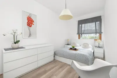 a white bedroom with a bed and a white dresser at Nowoczesny & Klimatyzowany Apartament z Parkingiem by Noclegi Renters in Kraków