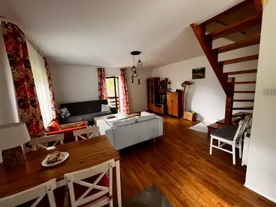 a living room with a couch and a table at Domek Ciśniawa in Sidzina