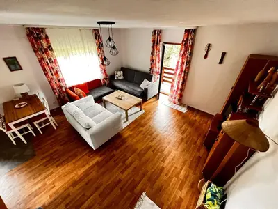 a living room with a couch and a table at Domek Ciśniawa in Sidzina