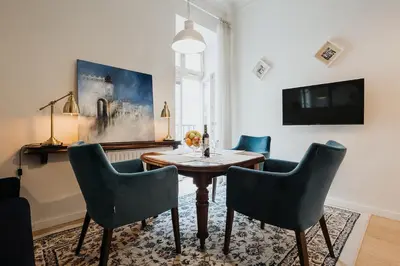 a dining room with a table and chairs and a tv at TOP Cracow Main Hub in Kraków