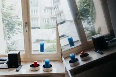 a room with a window with blue and red candles at TOP Cracow Main Hub in Kraków