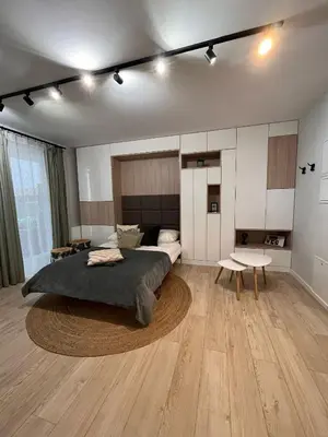 a bedroom with a large bed and a table at Cubicle 22 Garden & Free Parking in Kraków