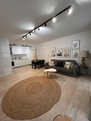 a living room with a couch and a table at Cubicle 22 Garden & Free Parking in Kraków