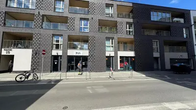 a building with a bike parked in front of it at Cubicle 22 Garden & Free Parking in Kraków