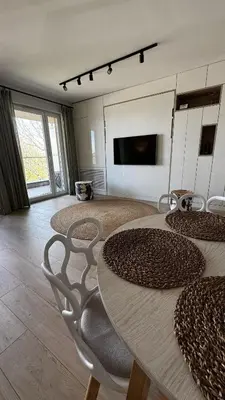a room with tables and chairs and a tv at Cubicle 52 Terrace & Free Parking in Kraków