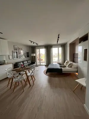 a large living room with a bed and a table at Cubicle 52 Terrace & Free Parking in Kraków
