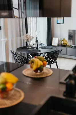 a table with two plates of fruit on it at Cubicle 72 Studio Big Terrace in Kraków