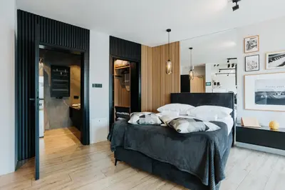 a bedroom with a bed with two pillows on it at Cubicle 72 Studio Big Terrace in Kraków