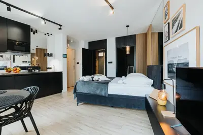 a hotel room with a bed and a kitchen at Cubicle 72 Studio Big Terrace in Kraków