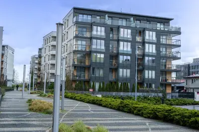 an apartment building in a city with a parking lot at Vistula Boulevard Apartment with free parking spot in Kraków