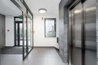 an empty hallway with doors to a building at Vistula Boulevard Apartment with free parking spot in Kraków