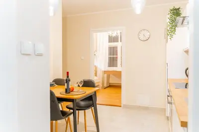 a kitchen and dining room with a table and chairs at Bayview on Długa - By Hosty in Kraków