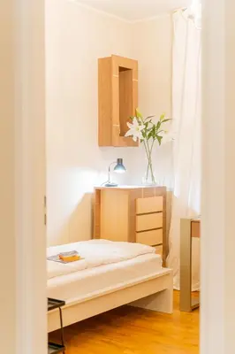 a small bedroom with a bed and a mirror at Bayview on Długa - By Hosty in Kraków