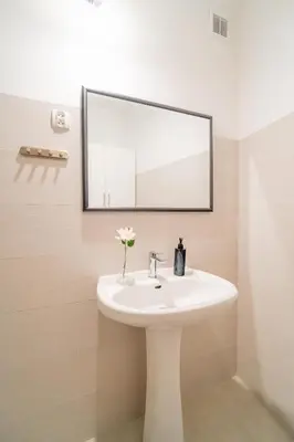 a bathroom with a white sink and a mirror at Bayview on Długa - By Hosty in Kraków