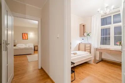 a white room with a bed and a window at Bayview on Długa - By Hosty in Kraków