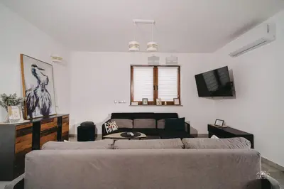 a living room with a couch and a tv at Widokówka Kudłacze Domek z Jacuzzi in Pcim