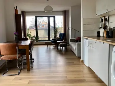 a kitchen and living room with a table and a couch at KrakowCharm private apartment Old Town in Kraków