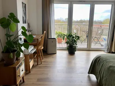 a bedroom with a bed and a table with a desk at KrakowCharm private apartment Old Town in Kraków