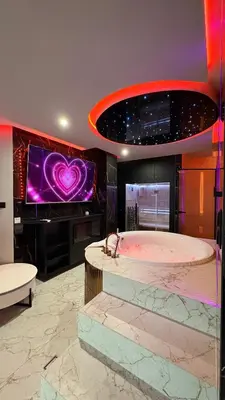 a large bathroom with a tub with a heart on the wall at Jacuzzi Glass-House Wislane Tarasy with Sauna and Parking in Kraków