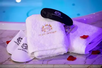 a pile of towels sitting on top of a table at Jacuzzi Glass-House Wislane Tarasy with Sauna and Parking in Kraków