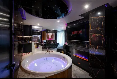a bathroom with a large tub in a room at Jacuzzi Glass-House Wislane Tarasy with Sauna and Parking in Kraków