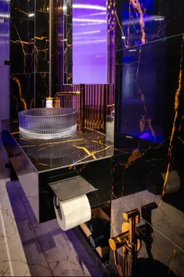 a bathroom with a toilet paper dispenser and a television at Jacuzzi Glass-House Wislane Tarasy with Sauna and Parking in Kraków