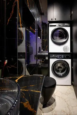 a laundry room with a washer and a washing machine at Jacuzzi Glass-House Wislane Tarasy with Sauna and Parking in Kraków